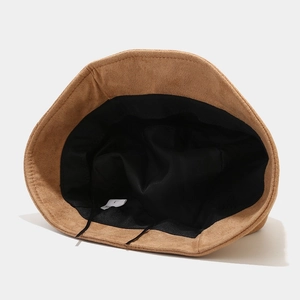 Brown faux suede bucket hat featuring a short brim and adjustable inner lining