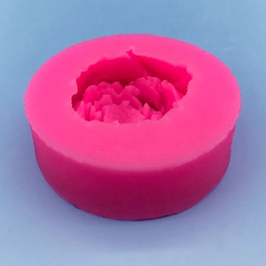 Pink peony silicone mold for candle making with detailed petal texture on blue background