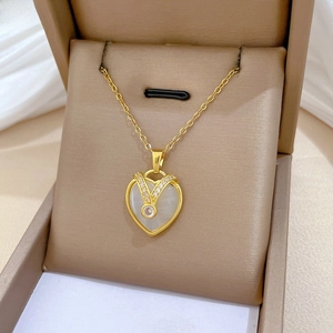 Close-up of heart cat-eye stone necklace with pavé diamonds in a jewelry box