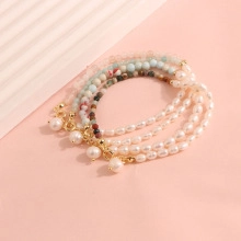 Detail of four layers baroque freshwater pearl and natural stone beaded bracelets set