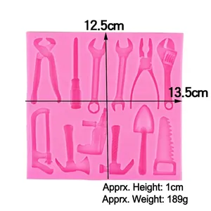 Pink silicone fondant mold featuring wrench, pliers, and hammer shapes for cake decoration