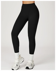 Detail of high waisted black compression leggings fabric and supportive athletic waistband