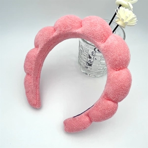 Detail of pink sponge headband featuring soft terry cloth texture and thick cloud design