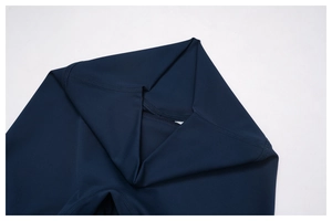 Detail of high-waisted navy yoga shorts with durable flatlock stitching and elastic fabric