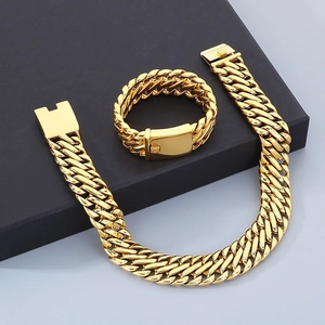 Detail of 23mm golden braided Cuban chain bracelet and necklace set for men on display