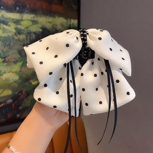 Elegant white polka dot bow hair claw clip with black silk ribbons for a stylish hairstyle