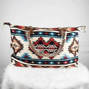Ethnic pattern canvas weekender bag with brown leather handles and golden metal hardware
