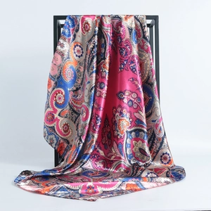 Detail of bohemian paisley print on glossy 90x90cm satin silk scarf with drape effect