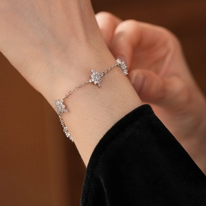 Gros plan d'un bracelet étoilé en argent avec zircons pavés sur le poignet d'un mannequin