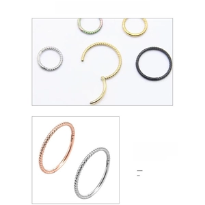 Detail showing various colors of twisted rope pattern 316L stainless steel clicker rings