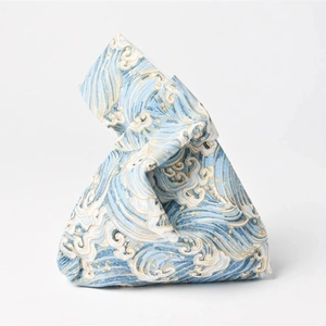Detail of blue Japanese knot bag featuring traditional Seigaiha wave pattern fabric