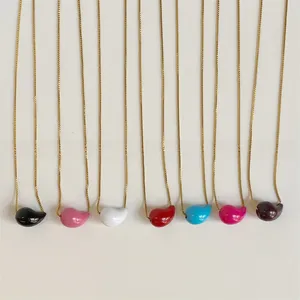 Detailed view of colorful enamel bean pendants on elegant gold chains in various colors