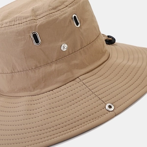Dettaglio ravvicinato del cappello da pescatore impermeabile kaki con occhielli in metallo