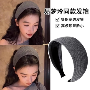 Detail of grey knitted wide headband with vertical ribbed texture and thick structure
