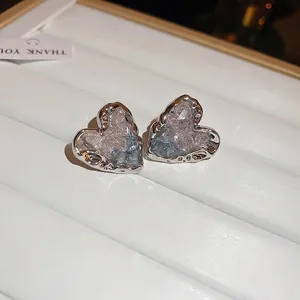 Silver-edged heart crystal stud earrings with ice-crackle texture in a white gift box
