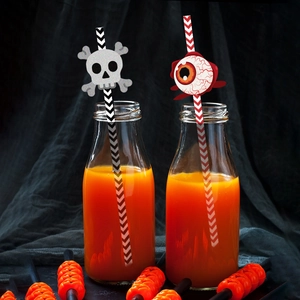 Halloween straws with glitter skulls and eyes on black and white ripple paper patterns