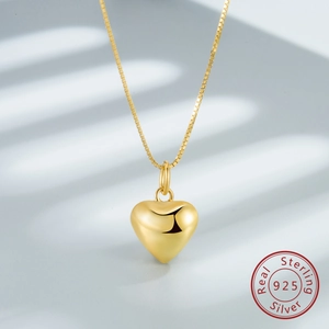 Macro detail of 925 sterling silver heart pendant with elegant 18k gold plating finish