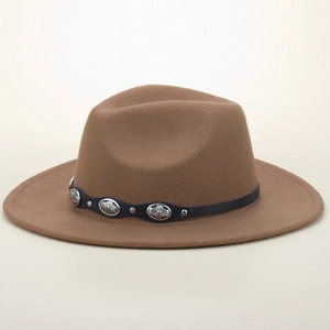 Detail of brown fedora hat featuring black band with silver embossed metal studs