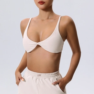 Ribbed beige workout set featuring a twist-front V-neck top and high waist leggings