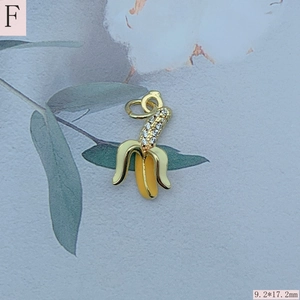 Macro detail of a 9.2x17.2mm gold banana pendant with zircon accents for DIY jewelry