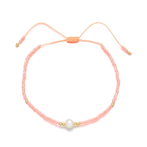 Detail of pink seed bead bracelet with a freshwater pearl and adjustable woven cord