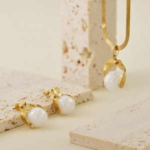 Elegant gold snake chain necklace and stud earring set with pearl and spiral charm