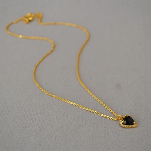 Elegant gold-plated brass necklace with faceted black heart pendant and sparkling zircons