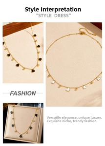 Detail view of heart pendants on gold-plated chain with zircon accents in black and white