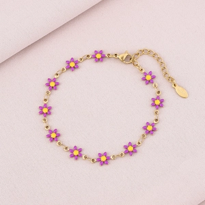 Close-up of golden stainless steel chain featuring purple and yellow daisy enamel charms