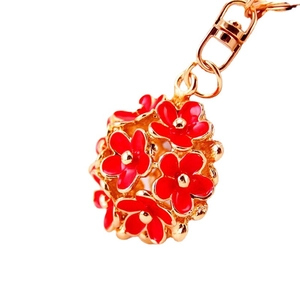 Golden 3D daisy flower keychain with red enamel petals and secure lobster clasp