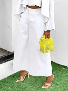 Detail of white high-waisted wide-leg trousers with structured fabric for a clean silhouette