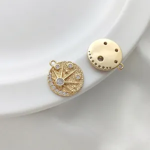 Detailed macro view of 14K gold-filled sun and moon charm with white zircon stones
