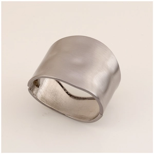 Detail of wide brushed silver metal cuff featuring a minimalist irregular design