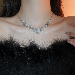 Collier en V argenté à pampilles avec pierres claires porté par un mannequin