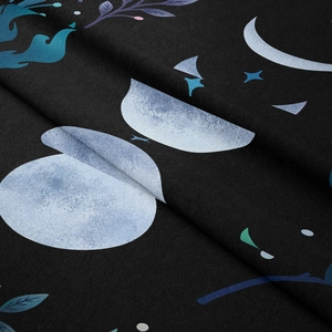Detail of bohemian tapestry texture showing moon phase prints on black fabric