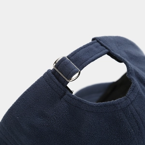 Detailed close-up of navy blue fleece baseball cap with adjustable silver metal buckle