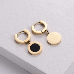 Gold-plated huggie hoop earrings with black round pendant featuring Roman numeral engravings