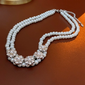 Detailed view of double-layer pearl choker with sparkling floral crystal pendants