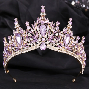 Macro detail of bridal crown featuring leaf motifs and purple crystals on gold