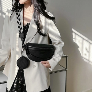 Black crescent waist bag with embossed patterns, silver chain and geometric strap