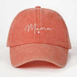 Close-up of Mama text and heart embroidery on washed orange cotton baseball cap