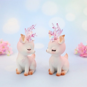 Detail of pink gradient deer figurines with sparkling antlers for car or desk decoration
