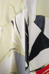Detail of elegant satin fabric with abstract floral patterns and geometric prints