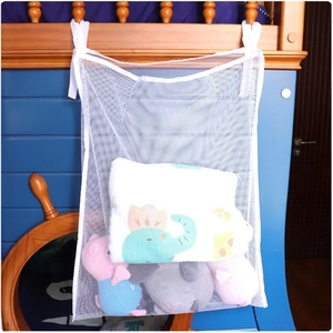 Hanging mesh storage bag for toys on a wooden bunk bed showing large capacity storage