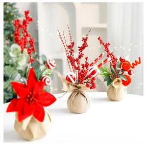Close-up of Christmas linen base pots with red berries, pine cones and candy cane decorations