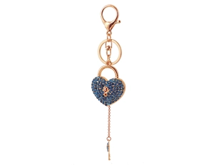 Detail of rose gold heart lock keychain with blue rhinestones and small key charm