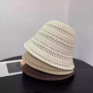 Close-up of three crochet bucket hats showing openwork knit patterns in beige and brown