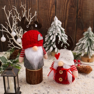 Christmas gnome dolls with reindeer horn hats and white beards on a winter snow scene