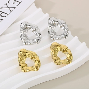 Irregular textured hoop earrings in gold and silver finish with minimalist wave design