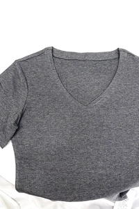 Close-up of grey V-neck knit t-shirt fabric texture and neckline stitching detail